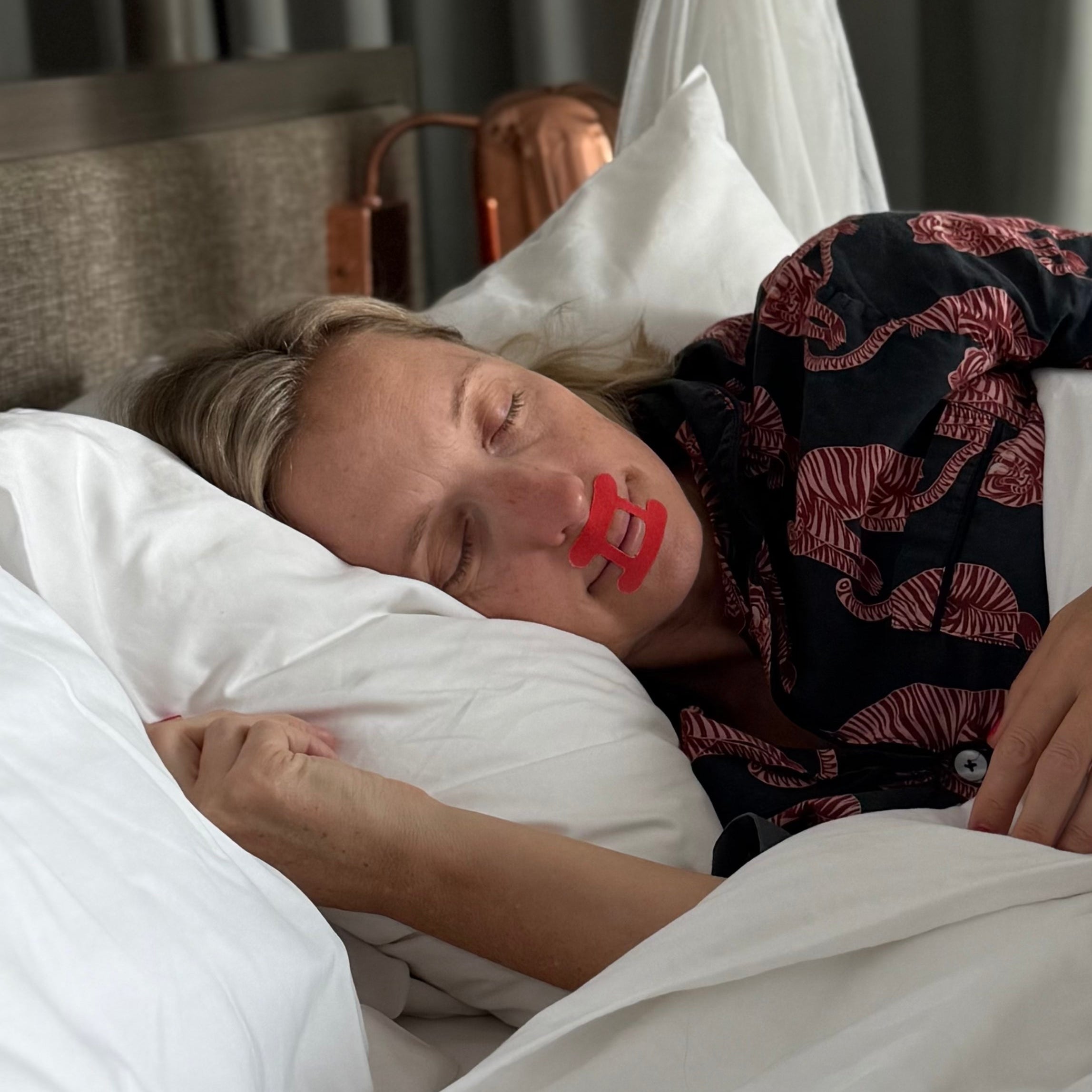 Lady sleeping restfully wearing kip&glow mouth tape