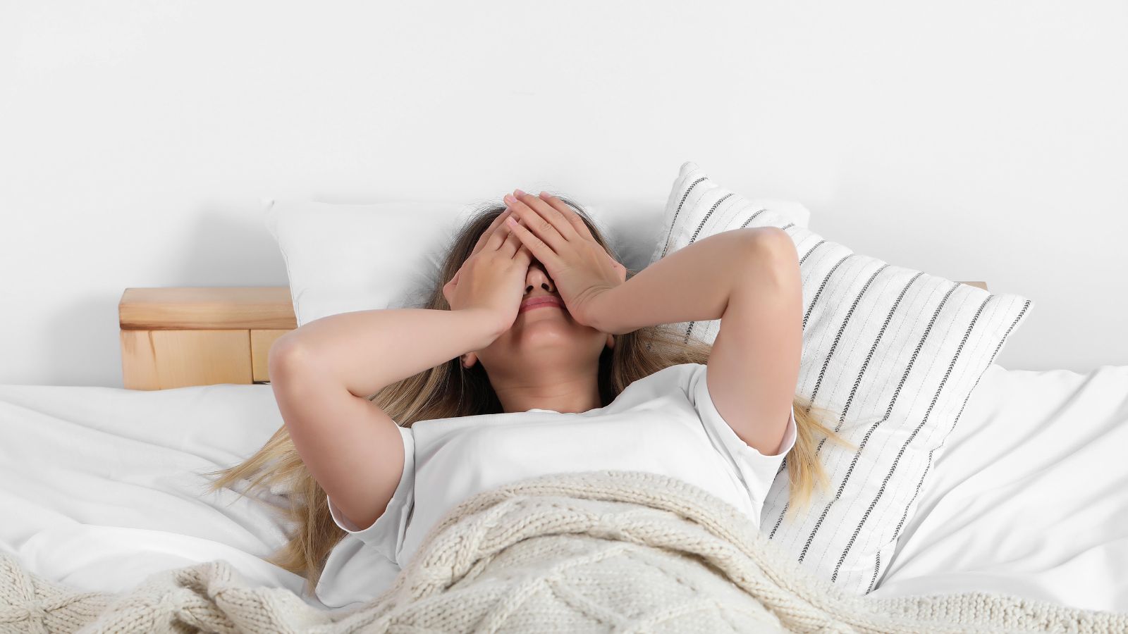 Woman struggling to sleep in bed