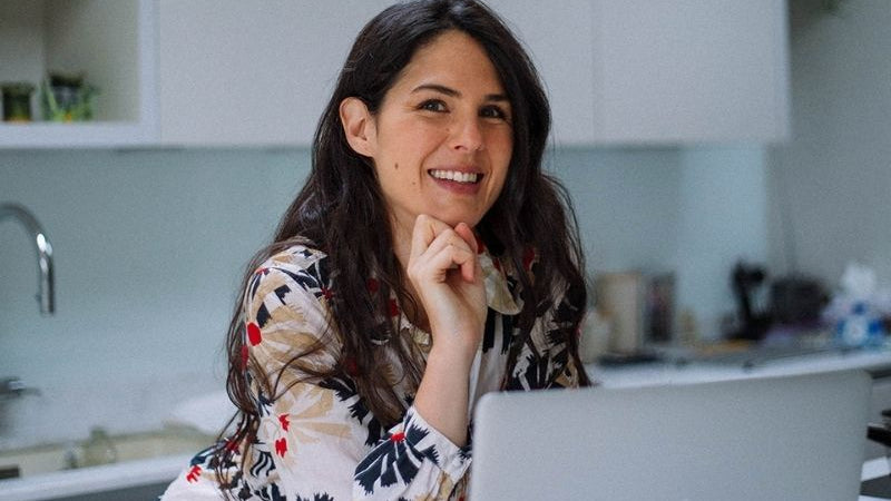 Woman sat at laptop smiling