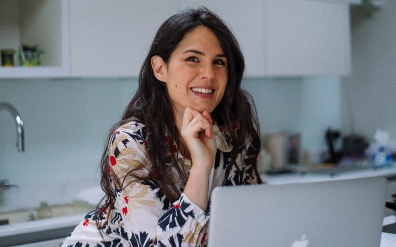 Woman sat at laptop smiling