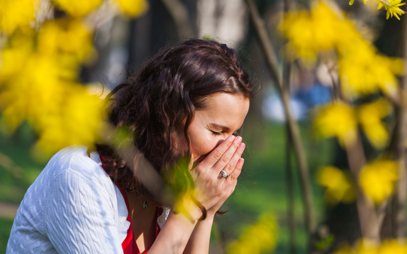 Woman sneezing in hay fever season