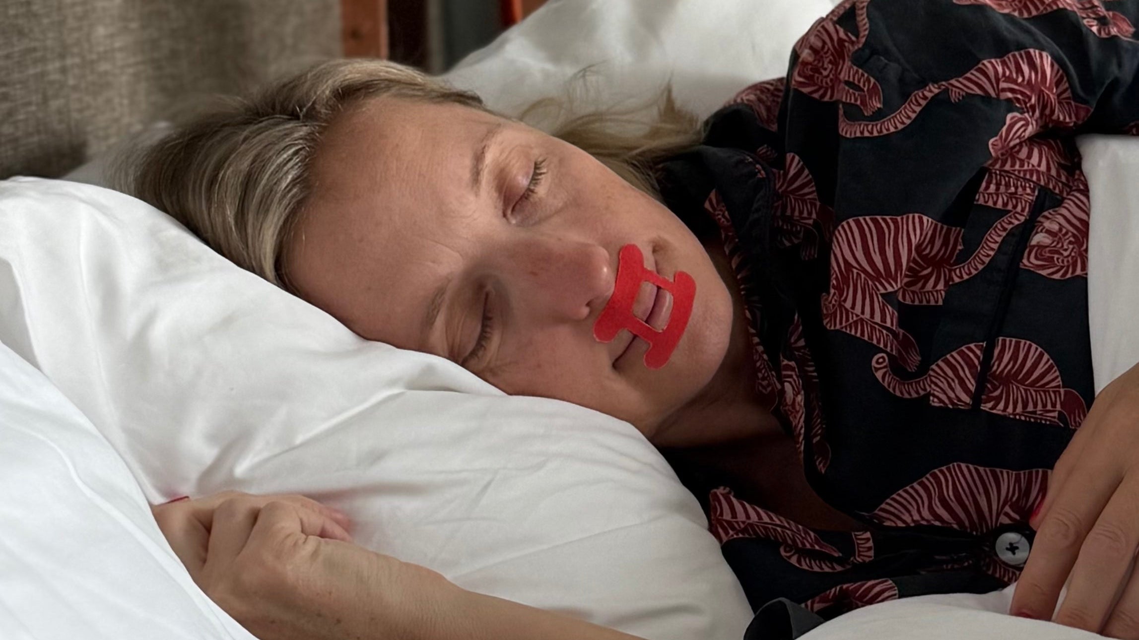 Lady sleeping restfully wearing kip&glow mouth tape