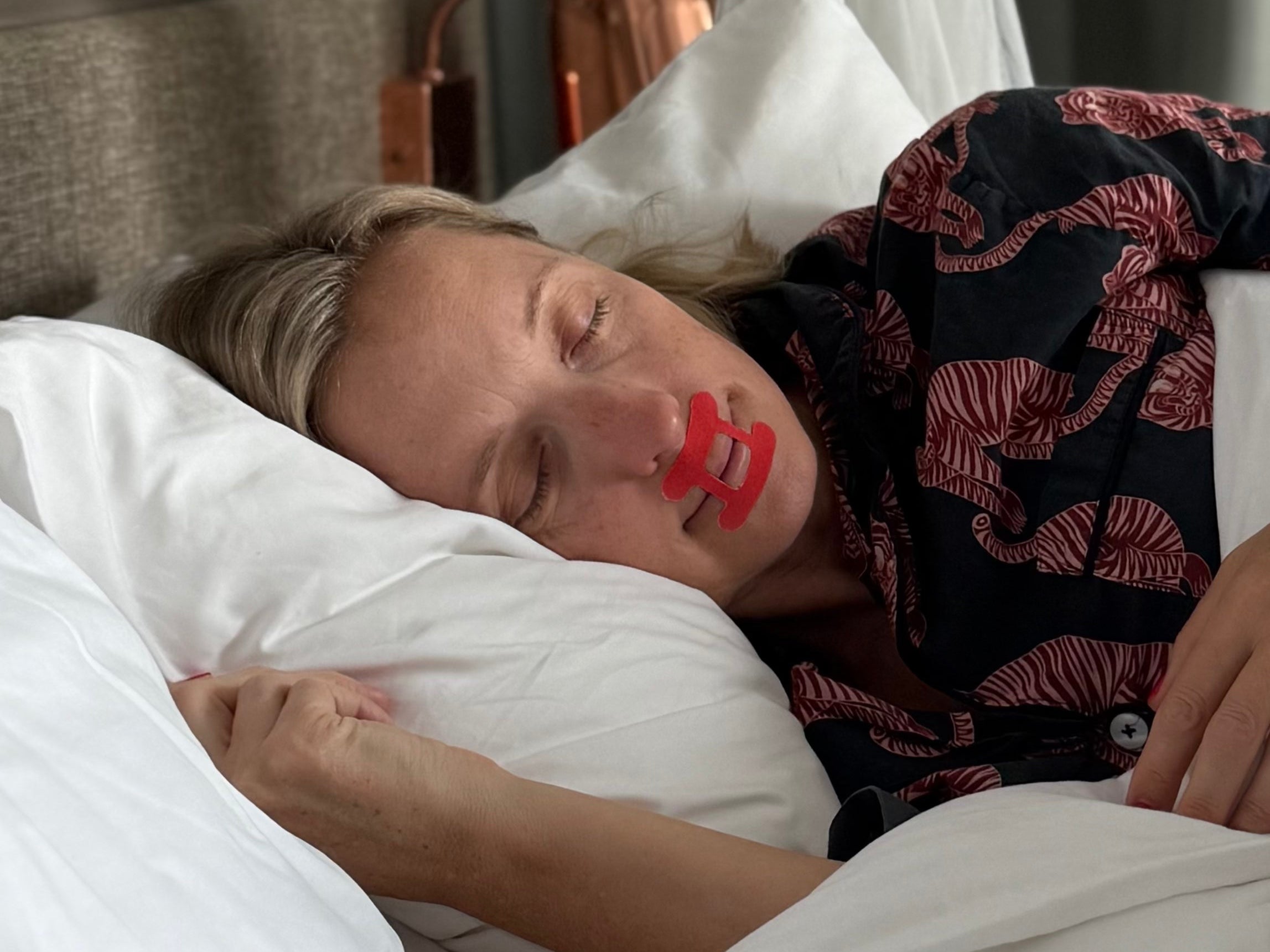 Lady sleeping restfully wearing kip&glow mouth tape