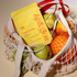 Net bag with fruit and a kip&glow Energy Patch packet on a beige background