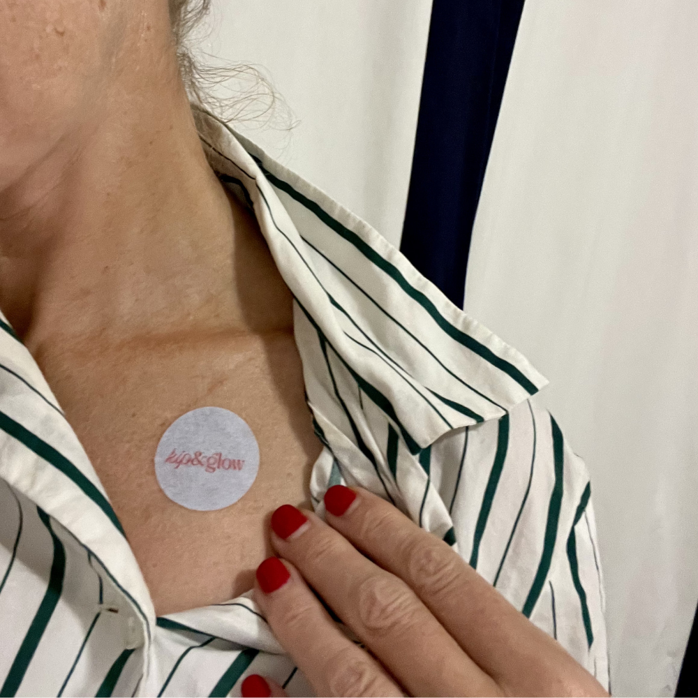 Person wearing a striped pyjama top, wearing a kip&glow Sleep Patch on her collarbone.