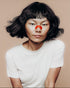 Person wearing a kip&glow nose strips and a white t-shirt on a beige background