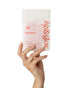 Hand holding a pouch of kip&glow Nose Strips