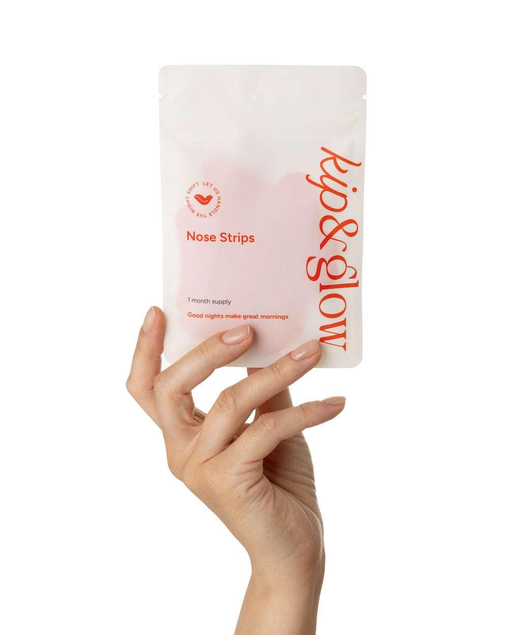 Hand holding a pouch of kip&glow Nose Strips