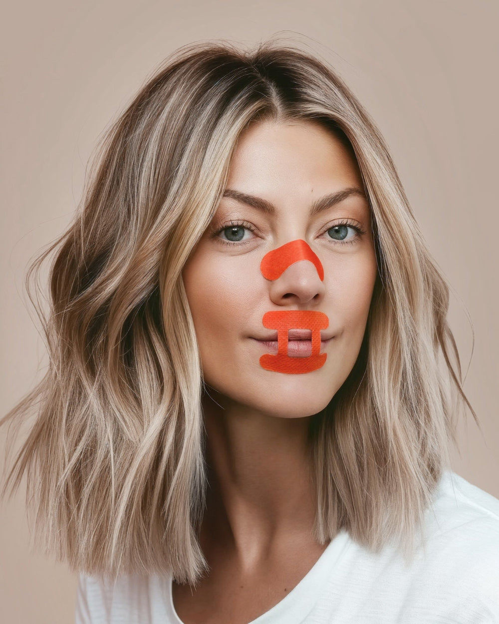 Woman wearing kip&glow Nose Strips across the bridge of the nose and Sleep Tape on her mouth