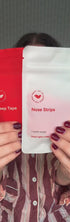 Woman wearing kip&glow nose strips and sleep tape